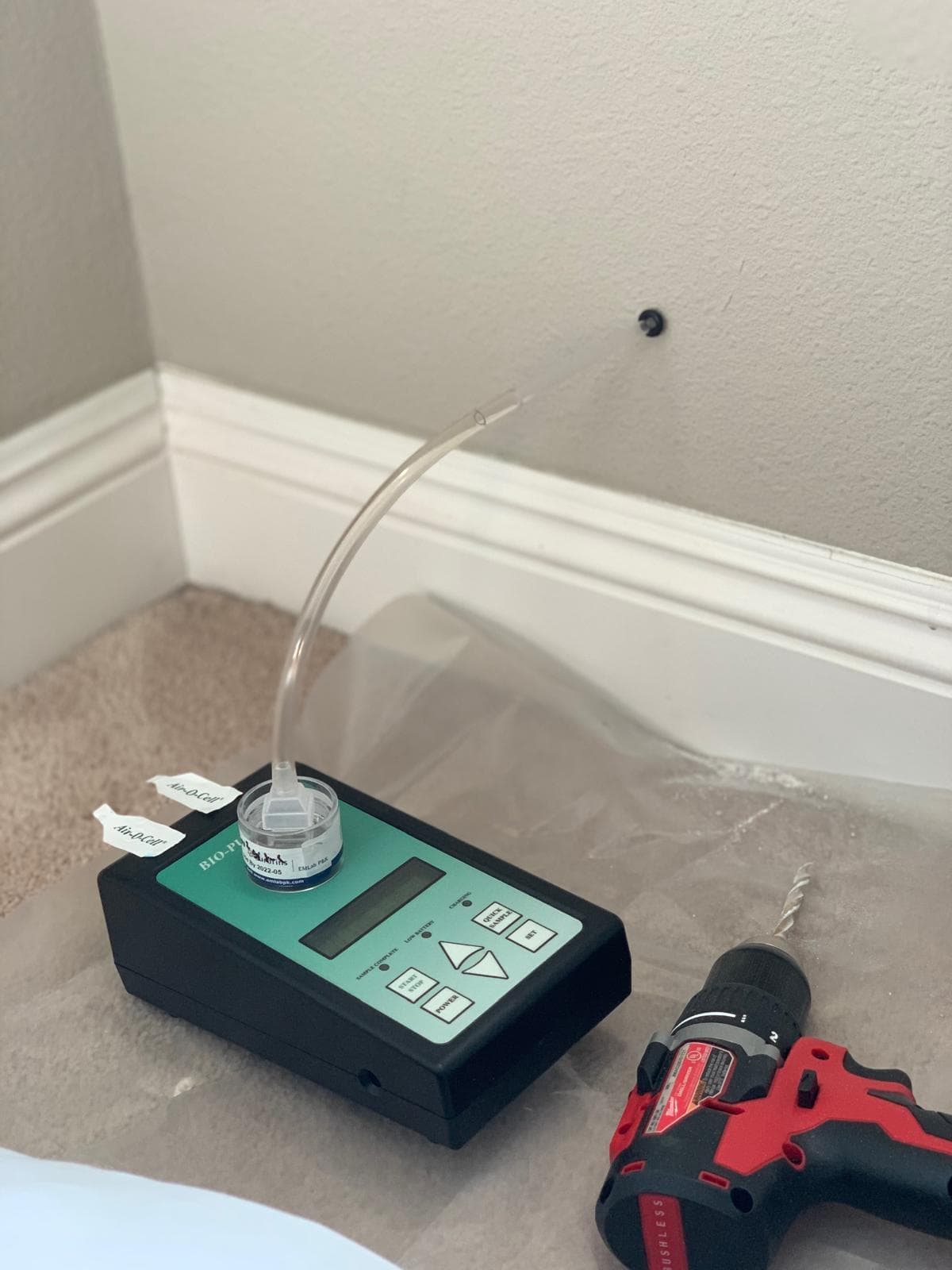Bio-Pump air sampler with Air-O-Cell cassette and drill set up for wall cavity air sampling