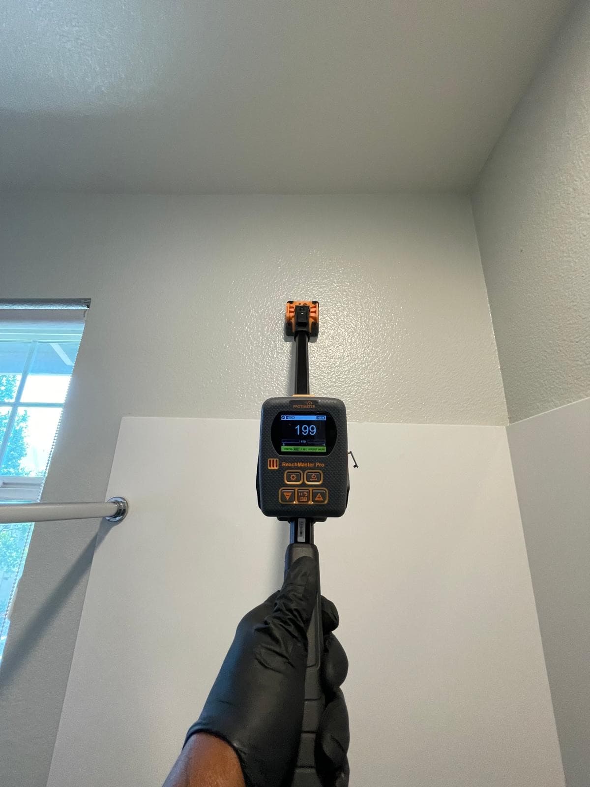 ReachMaster Pro moisture meter extended to a ceiling to detect prior and active moisture intrusion